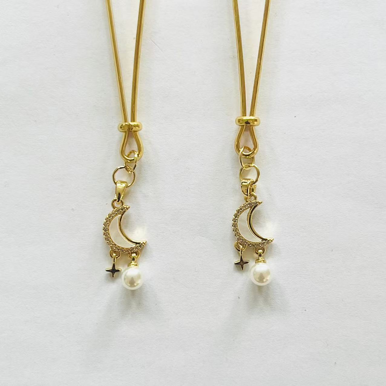 Gold nipple clamps with crescent moon, star charm, and pearl drop – PurpleNight.ca