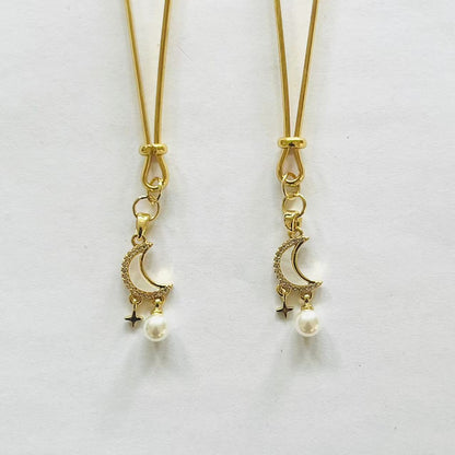 Gold nipple clamps with crescent moon, star charm, and pearl drop – PurpleNight.ca