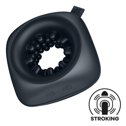 A small, black, ring-shaped vibrator with a textured surface and a power button, designed for sexual use. It is compact and portable, ideal for travel.